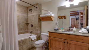 Full bath with vanity and tiled shower / bath combo