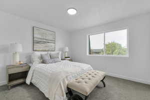 Bedroom with baseboards and carpet flooring