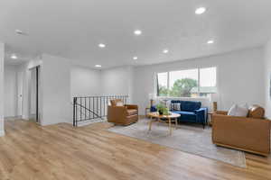 Living area with recessed lighting and light wood-style floors