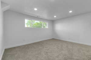 Carpeted spare room with recessed lighting and a textured ceiling