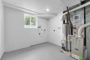 Utility room with gas water heater and heating unit