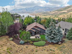 Aerial view of property and surrounding area featuring a water and mountain view