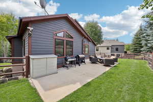 Back of house featuring an outdoor hangout area and a patio area