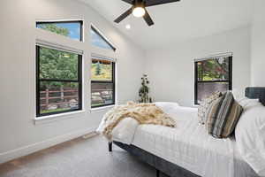 Bedroom with carpet, vaulted ceiling, a ceiling fan, and recessed lighting