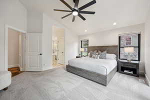 Bedroom featuring high vaulted ceiling, light colored carpet, a ceiling fan, ensuite bathroom, and recessed lighting