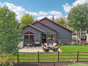 Back of house with outdoor lounge area and a patio
