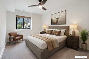 Carpeted bedroom featuring baseboards and ceiling fan