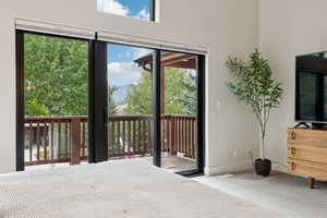 Bedroom with carpet and access to outside