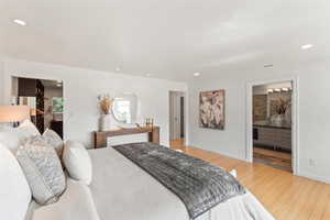 Bedroom featuring wood finished floors, recessed lighting, and ensuite bathroom