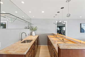 Kitchen featuring a peninsula, decorative light fixtures, light wood finished floors, and recessed lighting