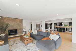 Living area featuring light wood finished floors, recessed lighting, wine cooler, and a chandelier