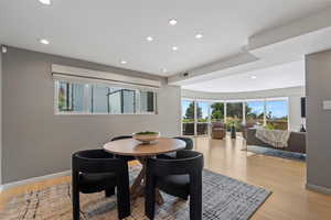Dining area with healthy amount of natural light, light wood-type flooring, and recessed lighting