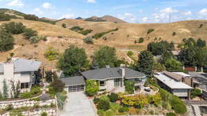 View of subject property with a mountain backdrop