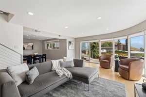 Living area with stairs, light wood finished floors, and recessed lighting