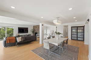 Dining area featuring light wood finished floors and recessed lighting