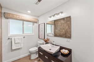 Bathroom with light tile patterned floors and vanity