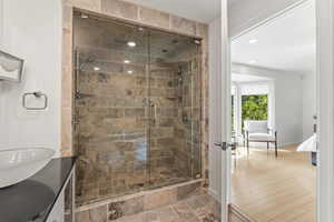 Full bath with connected bathroom, a shower stall, recessed lighting, and vanity