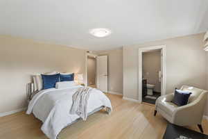 Bedroom featuring light wood-type flooring and connected bathroom