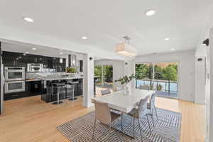 Dining space with recessed lighting and light wood-style floors