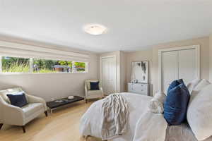Bedroom featuring multiple closets and wood finished floors