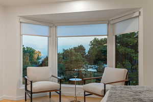 Bedroom featuring wood finished floors and multiple windows