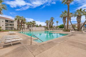 Community pool with a patio