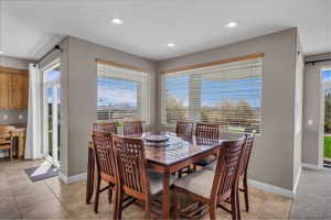 Dining area featuring recessed lighting and light tile patterned flooring