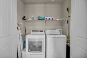 Laundry room featuring washing machine and clothes dryer