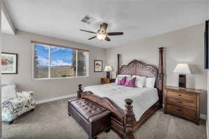 Carpeted bedroom featuring baseboards and a ceiling fan