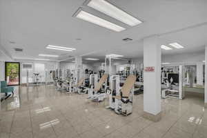 Exercise room featuring light tile patterned floors
