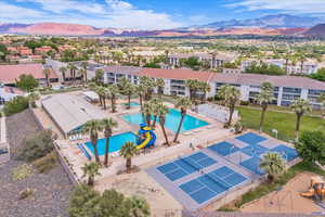 Aerial perspective of suburban area featuring mountains and a pool