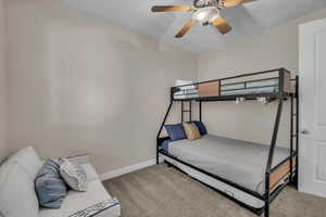 Carpeted bedroom with baseboards and ceiling fan