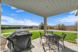 View of patio with grilling area and outdoor dining area