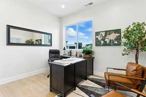 Office featuring light wood-type flooring and recessed lighting could be a 4th bedroom.