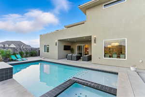 View of pool featuring a patio area and a pool with connected hot tub