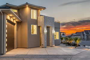 Contemporary home featuring stucco siding and stone siding