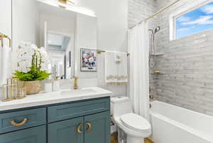 Full bathroom featuring vanity and shower / tub combo with curtain