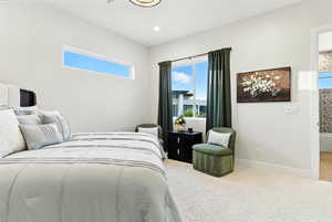Carpeted bedroom with baseboards and recessed lighting