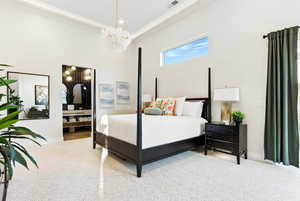 Large carpeted primary suite bedroom featuring private sitting area and patio.