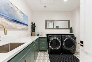 Laundry area featuring washer and dryer and cabinet space