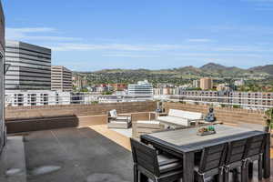 View of patio / terrace featuring a mountain view, a view of city, and outdoor lounge area