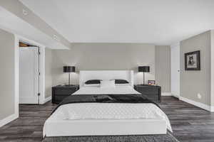 Bedroom with baseboards and dark wood finished floors