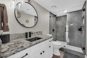 Bathroom with vanity and a stall shower