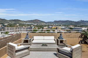 View of patio with a mountain view and an outdoor hangout area
