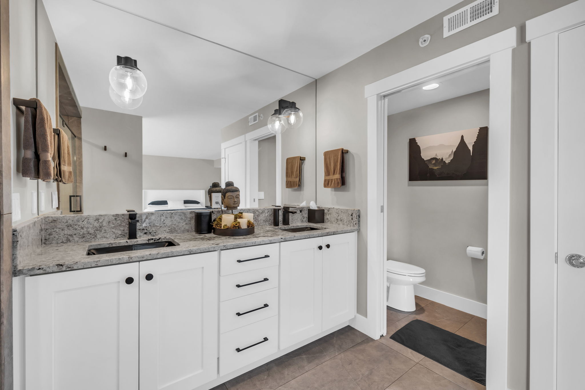Full bathroom with double vanity and light tile patterned floors