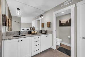 Full bathroom with double vanity and light tile patterned floors