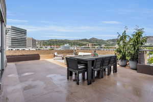 View of patio with a mountain view and outdoor dining area