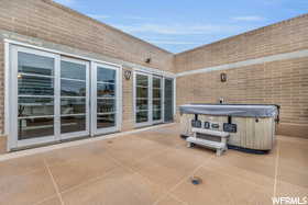 View of patio with a hot tub