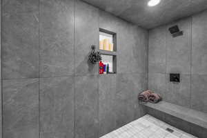 Bathroom with a tile shower and recessed lighting