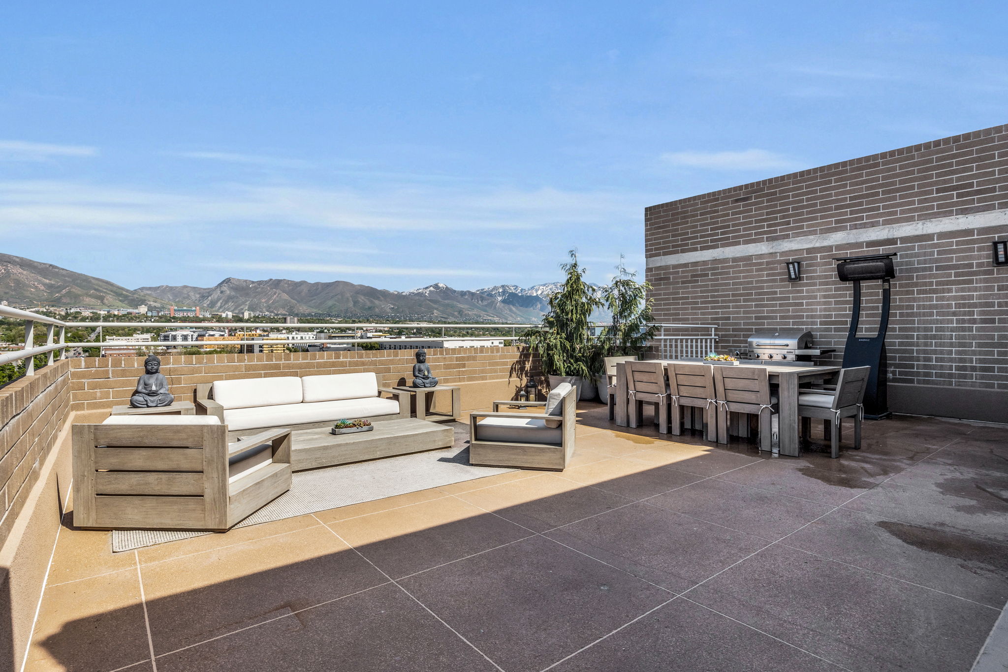 View of patio with an outdoor living space, a mountain view, and grilling area